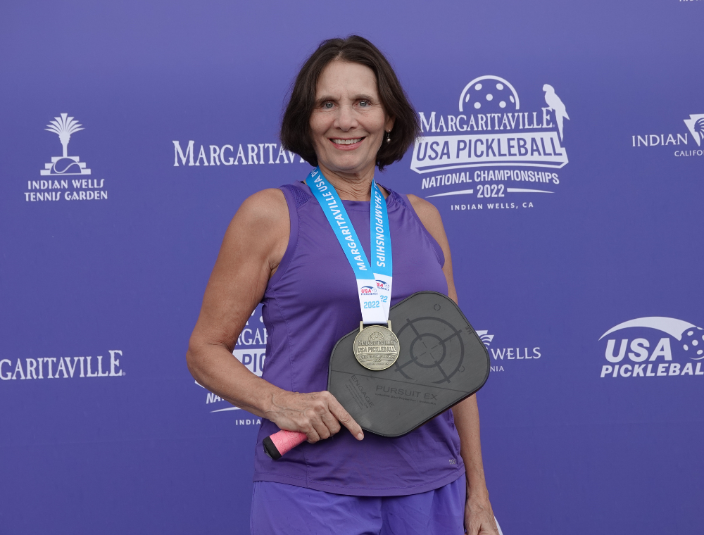 Judy Hoarfrost poses with her gold medal from the 2022 National Championships. Photo Credit: Carl Schmits