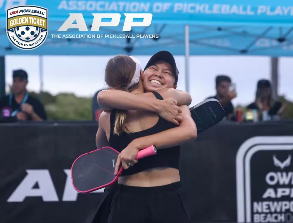 app-news-gt-2027 Two women embrace in celebration on a pickleball court, each holding paddles, with APD and Golden Ticket logos in the background.