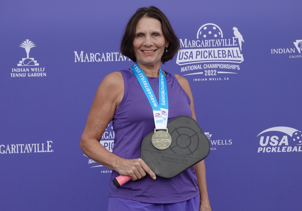 Judy Hoarfrost poses with her gold medal from the 2022 National Championships. Photo Credit: Carl Schmits